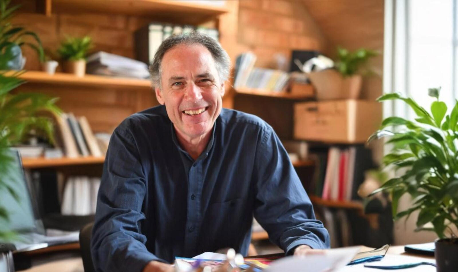 Herbert Renz-Polster smiling in his study